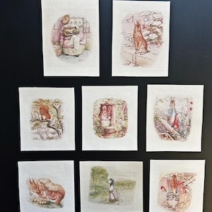 May include: A collection of eight rectangular fabric patches featuring classic Beatrix Potter illustrations. The prints depict various animals including a hedgehog, rabbits, a squirrel, a mouse, and a duck, rendered in soft, muted watercolour tones.