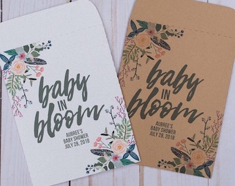 May include: Two brown and white paper favor bags with floral designs and the text "baby in bloom" and "Aubree's Baby Shower July 28, 2018".