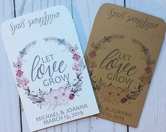 May include: Two white and brown paper envelopes with floral designs and the text "Let love grow". The white envelope has the text "Michael & Joanna March 13, 2019" and the brown envelope has the text "El & Joanna H 13, 2019".