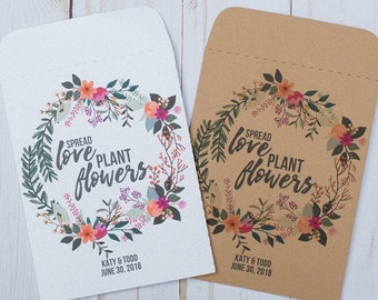 May include: Two seed packets with a floral wreath design. The text on the packets reads "Spread love plant flowers" and includes the names "Katy & Todd" and the date "June 30, 2018".