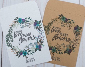 May include: Two white and brown paper envelopes with a floral wreath design. The text on the envelopes reads "Spread love plant flowers" with the date "June 30, 2018" and the names "Katy & Todd".