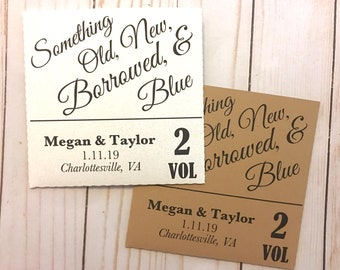 May include: Two brown and white cards with the text "Something Old, New, Borrowed, & Blue" and "Megan & Taylor 1.11.19 Charlottesville, VA 2 VOL" printed on them.