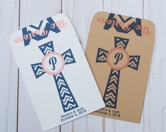 May include: Two custom wedding favor bags. One is white, the other is brown. Each features a navy blue cross design with a pink circle containing the letter "P". The text "The Partons" and the wedding date are printed on each bag.