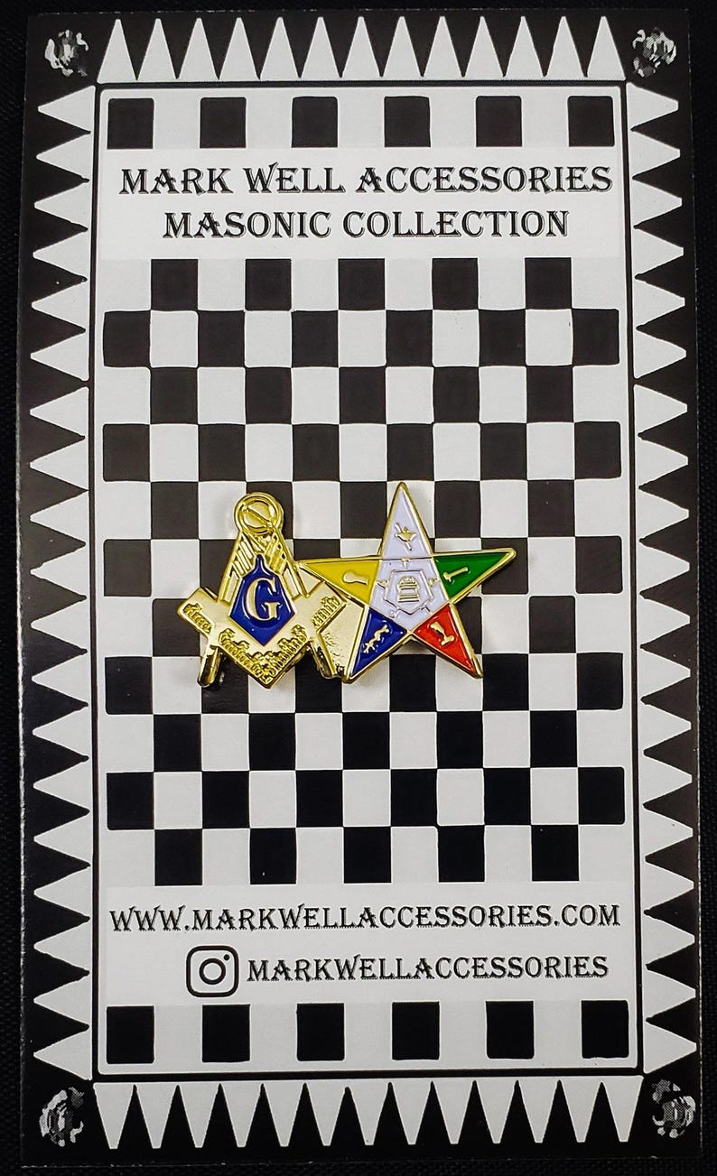 May include: A gold-tone metal lapel pin featuring a Masonic square and compass with a blue G, overlapping a five-pointed star with white, green, red, and blue enamel details, mounted on a black and white checkered display card with text.