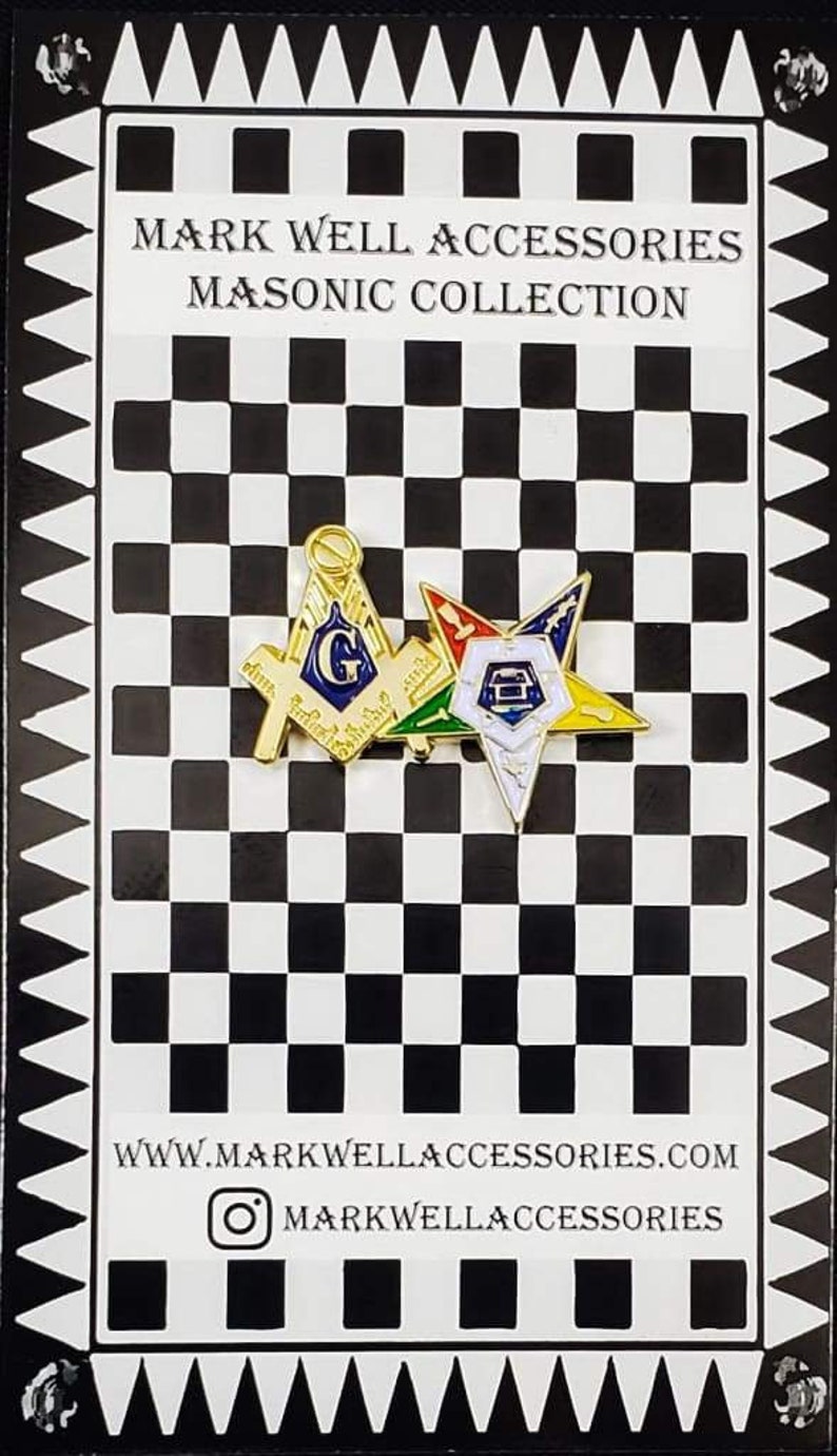 May include: A gold-toned Masonic lapel pin featuring a square and compass with a blue G, overlapping a multi-colored Order of the Eastern Star emblem. The pin is displayed on a black and white checkered card labeled Mark Well Accessories.