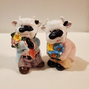 Black and White Cows holding flowers salt and pepper shakers