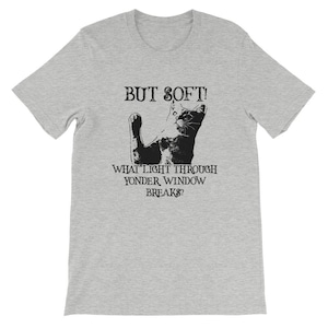 May include: A gray t-shirt with a black cat silhouette and the text "BUT SOFT! WHAT LIGHT THROUGH YONDER WINDOW BREAKS?"