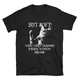 May include: Black t-shirt with a white cat silhouette and the text "But soft! What light through yonder window breaks?"