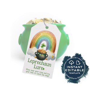May include: A green ceramic pot filled with gold coins, with a tag that reads "Leprechaun Lure." The tag features a rainbow, a pot of gold, and a four-leaf clover. The text on the tag says "Place near your trap and try your luck to catch the chap!"