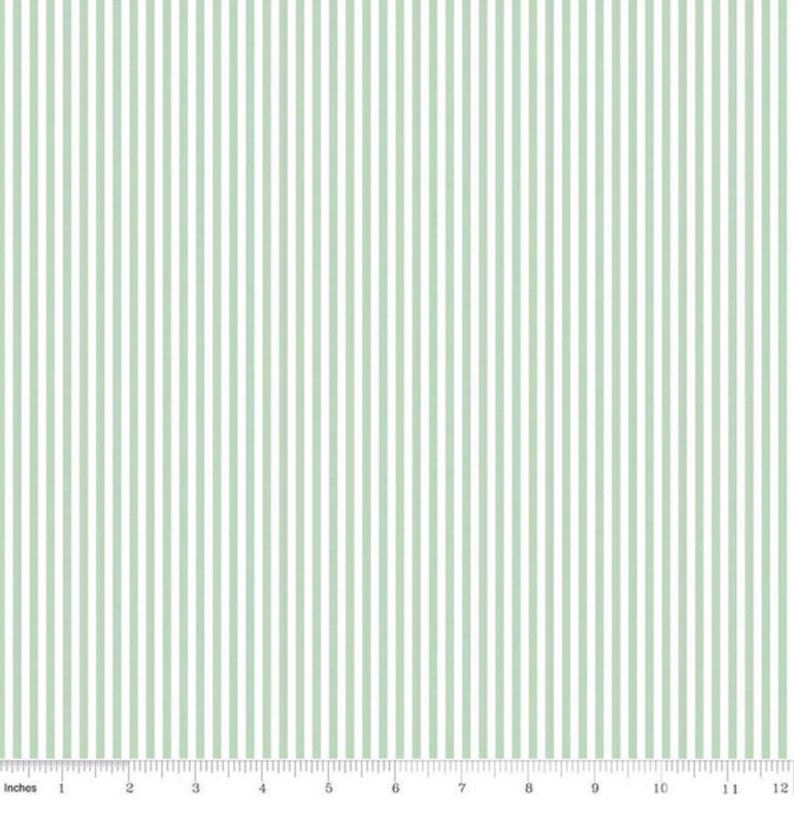 May include: A white fabric with thin, evenly spaced, light green stripes. The fabric is a classic striped pattern.