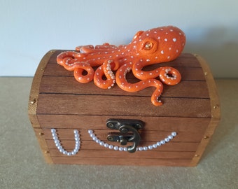 Orange Polymer Clay Octopus on a Wooden Treasure Chest