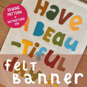 Könnte beinhalten: Ein Filzbanner mit den Worten "Have a Beautiful Felt Banner" in verschiedenen Farben. Das Banner besteht aus einem hellfarbenen Stoff mit bunten Filzbuchstaben. Ein rosa Kreis oben links zeigt "Sewing Pattern + Instructions PDF".