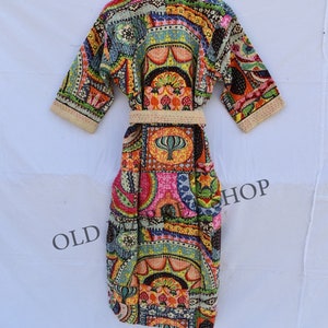 May include: A colorful, patterned robe with a sash. The robe is made of a patchwork of different fabrics and has a floral design. The robe is tied at the waist with a sash.