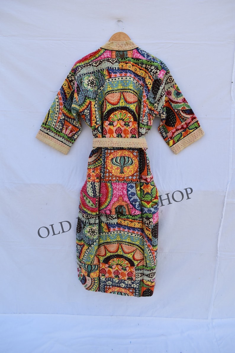 May include: A colorful, patterned robe with a sash. The robe is made of a patchwork of different fabrics and has a floral design. The robe is tied at the waist with a sash.