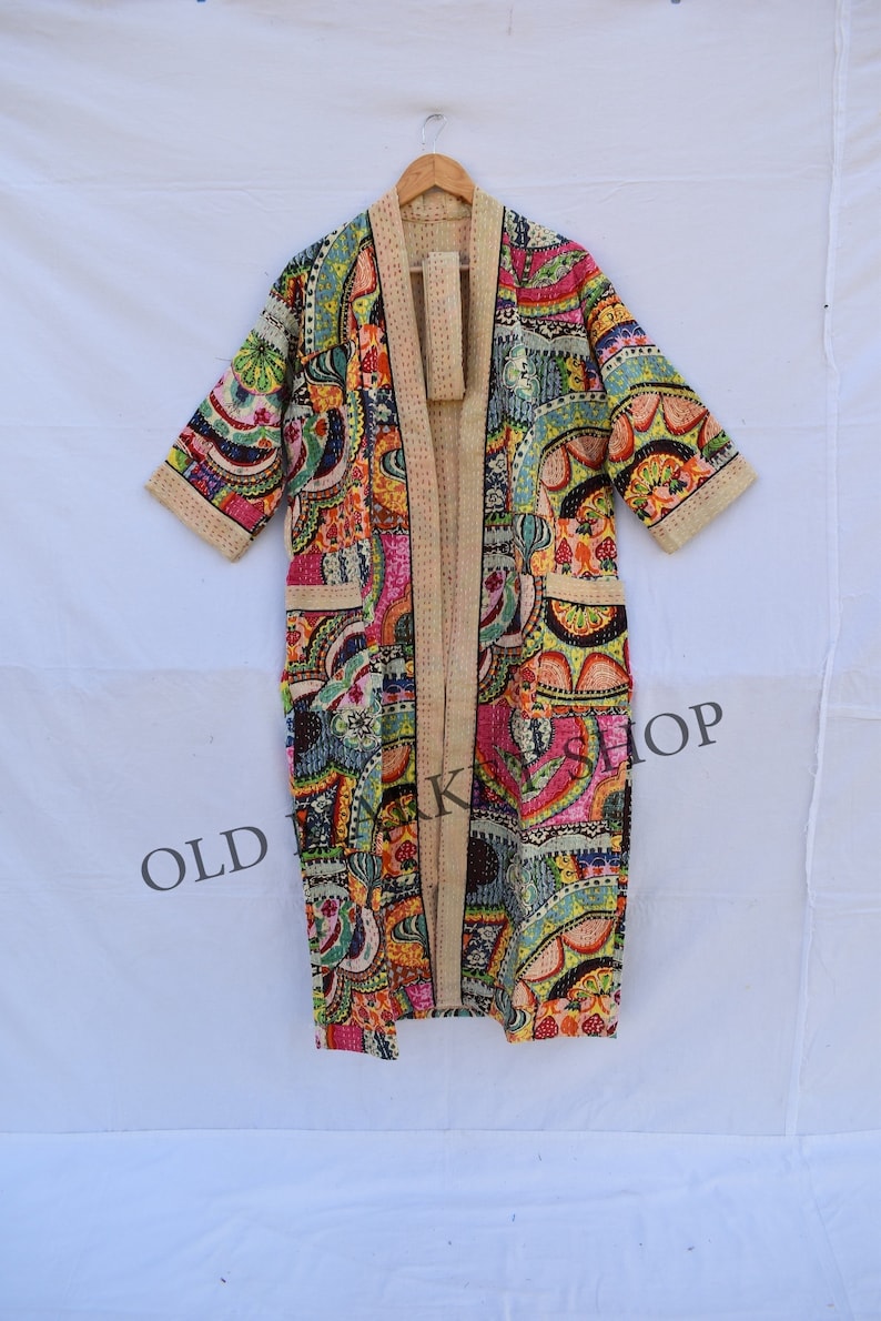 May include: A long, colorful, patterned robe with a cream-colored background. The robe has a long, open front and three-quarter sleeves. The robe is made of a soft, lightweight fabric and is perfect for lounging around the house.