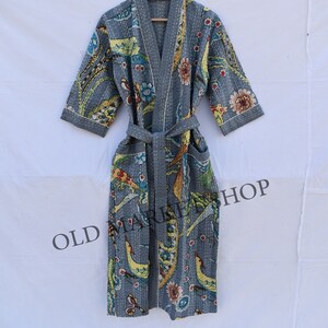 May include: A gray cotton robe with a floral print and a tie belt. The robe has a quilted design and is made in India.