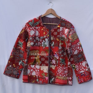 May include: Red quilted jacket with a floral and animal print pattern. The jacket has a button closure and long sleeves.