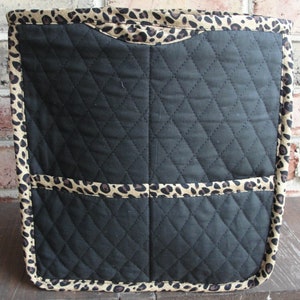 May include: Black quilted storage bin with a leopard print trim. The bin has three compartments.