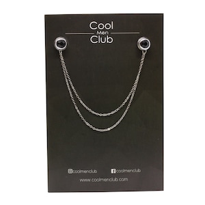 May include: A silver chain with two black round stones on each end. The chain is displayed on a black card with the text "Cool Men Club" and the website address "www.coolmenclub.com".