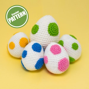 May include: Five crocheted eggs with different coloured polka dots. The eggs are white with green, yellow, blue, and pink polka dots. The text "Crochet PATTERN" is in a green circle in the top left corner of the image.