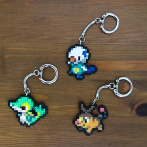 Snivy, Oshawott and Tepig keychains, pins, brooches, magnets or earrings