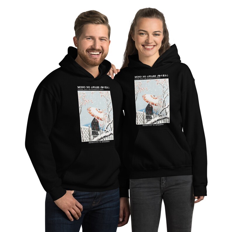 May include: Black hooded sweatshirts featuring a Japanese-inspired art print. The print includes a figure with an umbrella, cherry blossoms, and the text "MONO NO AWARE" and "SENSITIVITY TO IMPERMANENCE".