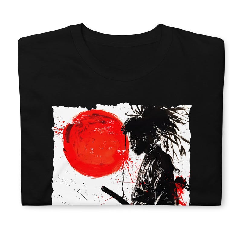 May include: Black t-shirt featuring a graphic design of a samurai with a red sun in the background. The design is in black and white with red accents, creating a striking contrast. The samurai is holding a sword.