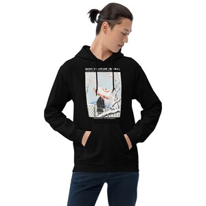 May include: Black hoodie with a front pocket and a graphic print. The print features a Japanese-style illustration of a person with an umbrella in a snowy landscape. Text at the top reads "MONO NO AWARE" and "SENSITIVITY TO EPHEMERA" at the bottom.