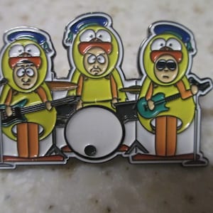 May include: Three cartoon characters dressed as yellow ducks playing instruments in a band. The character on the left is playing a green electric guitar, the character in the middle is playing a drum set, and the character on the right is playing a blue electric guitar.