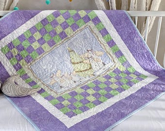 May include: A square quilt featuring a central panel with a light blue background and a printed illustration of a pear, surrounded by a checkered border of light green and purple squares, and an outer purple border with a floral pattern.