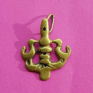 Copper look a like medal pendant, medaillon, medallion, charm of a apart shaped figure, mytologic?