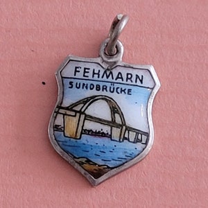 May include: A white ceramic mug with a black handle and the text "But First, Coffee" in a bold, black font. The mug is sitting on a wooden surface. The mug is approximately 4 inches tall.