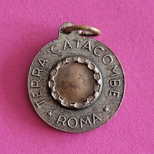 Religious Italian catholic silvered medal pendant relic reliquary holy charm of Pope Paulus VI Pontifex Max and Earth of the Catacombe Roma.