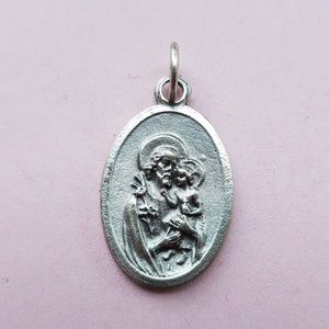 Religious antique silvered French catholic medal pendant, holy charm, medallion of Saint Joseph and Child Jesus with the Holy Family.