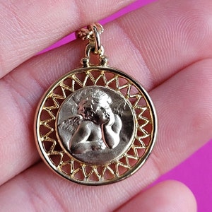 Vintage religious gold light plated catholic medal pendant, charm of a cherub, archangel, guardian angel with necklace.