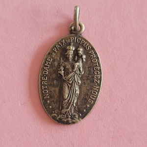 Religious French catholic silver plated medal pendant holy charm medallion of Holy Mary our Lady, Virgin Mary of peace, Lourdes, France.