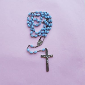 Religious antique French catholic rosary with light blue glass beads and a silver plated crucifix with Jesus Christ.