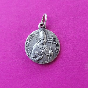 Religious antique silvered catholic Belgian medal pendant medaillon medallion holy charm of Saint Cornelius in Diechem, Diegem, Belgium.