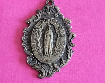 Religious antique silvered catholic holy charm medal pendant medallion of Holy Mary of Namur a pilgrimage town in Belgium.