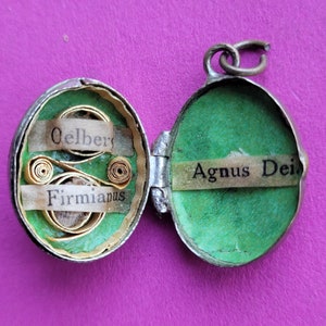 Museum antique reliquary medal pendant shrine with stunning relic of Agnus Dei and Virgin Mary with Child Jesus in Altötting, Germany.