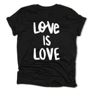 May include: Black t-shirt with white text that reads "Love is Love".