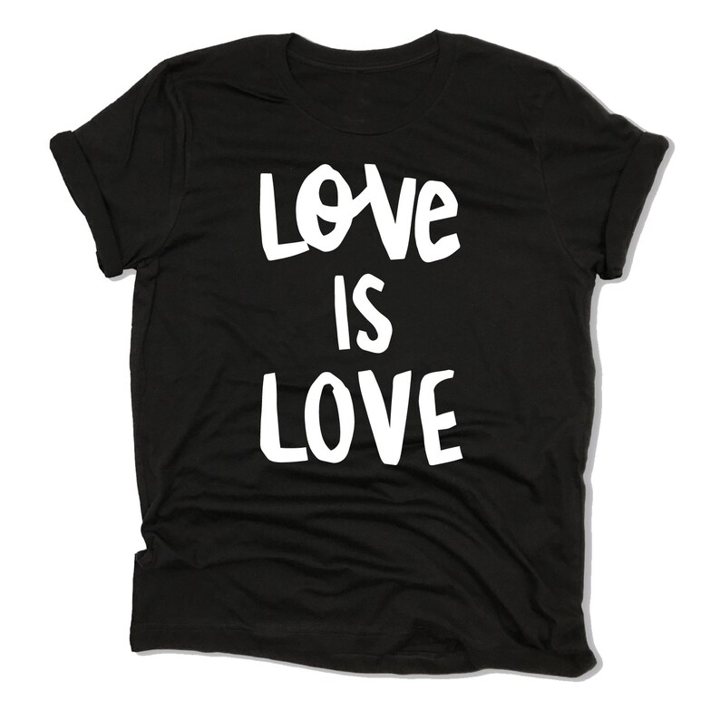 May include: Black t-shirt with white text that reads "Love is Love".