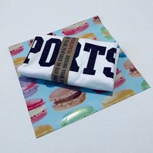 May include: White t-shirt with black glitter lettering that reads "PORTS" and a brown paper tag that says "MYGOLDPETAL ROCKING YOUR STYLE.  BE FEATURED ON OUR PAGE."