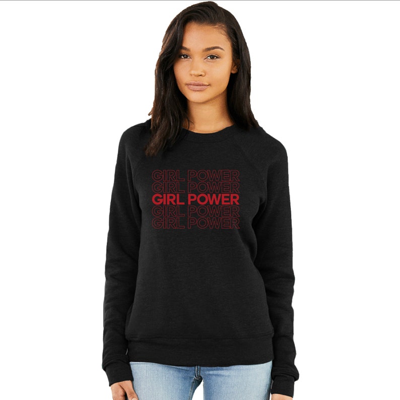 May include: Black sweatshirt with the phrase "GIRL POWER" repeated in red text.