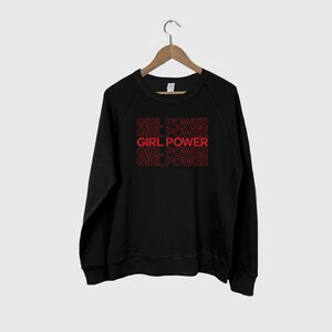 May include: Black sweatshirt with the phrase "GIRL POWER" repeated five times in red.