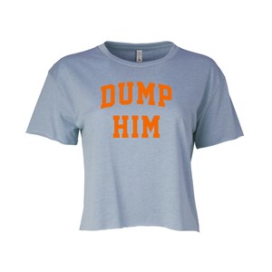 May include: A light blue cropped t-shirt with the text "DUMP HIM" in orange.