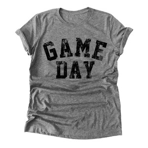 May include: A gray t-shirt with the text "GAME DAY" printed in black.