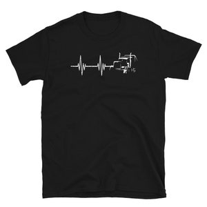 May include: Black t-shirt featuring a white graphic of a semi-truck and a heartbeat line. The graphic reads "My Heart Beats for Trucks".