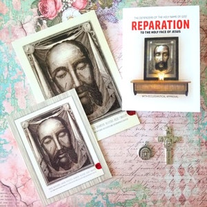 May include: Two small cards with a black and white image of Jesus' face on them. The cards have the text "US DOMINI NOSTRI JESU CHRISTI" and "ORA ETIFICES, ORA UTIFICES, ORA UTIFICES NOSTRI JESU CHRISTI". A larger card with the text "REPARATION TO THE HOLY FACE OF JESUS" and a black and white image of Jesus' face. The card has the text "THE DEFENDERS OF THE HOLY NAME OF GOD" and "WITH ECCLESIASTICAL APPROVAL". A silver cross with a small image of Jesus' face on it.