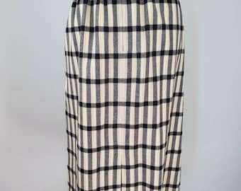 May include: A black and white plaid skirt with a zipper closure in the back. The skirt is knee-length and has a fitted silhouette.